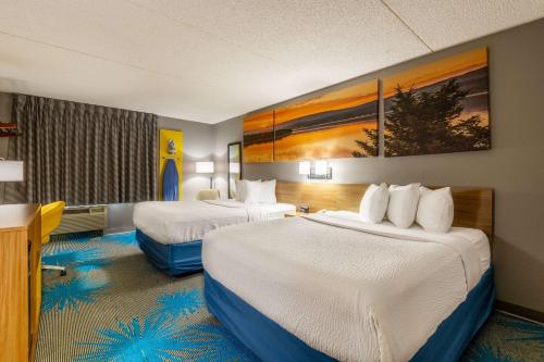 a hotel room with two beds in a room at Days Inn by Wyndham Coeur d'Alene in Coeur d'Alene