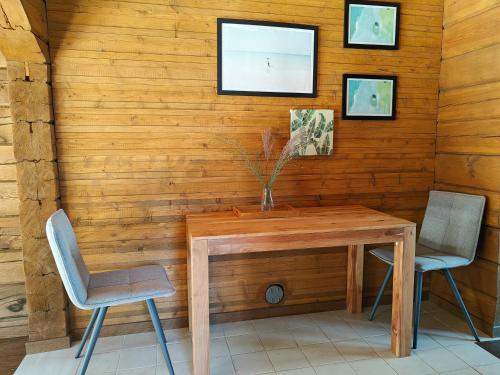 a wooden table and two chairs in a room at Sala Resort Plateliai & SPA in Plateliai