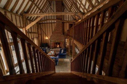 a hallway in a wooden barn with a fireplace at Manor Farm Barn in Eye