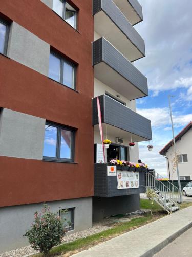a building with a balcony on the side of it at MONCLER RESIDENCE in Braşov