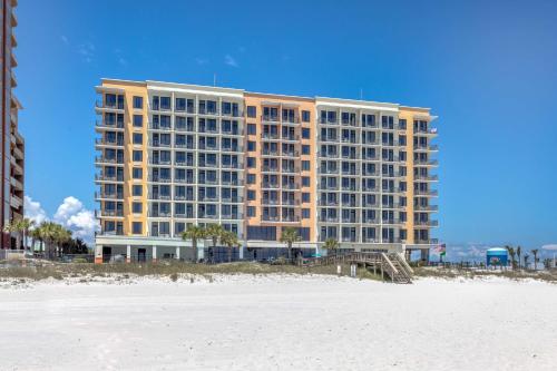 a large building on the beach with a beach gmaxwell gmaxwell at Hampton Inn & Suites - Orange Beach in Orange Beach