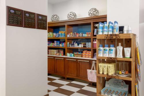a room with a shelf with products on it at Hampton Inn & Suites - Orange Beach in Orange Beach