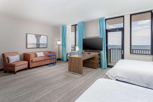 a hotel room with a bed and a flat screen tv at Hampton Inn & Suites - Orange Beach in Orange Beach