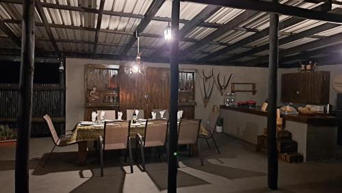 uma sala de jantar com mesa e cadeiras em Hambana Lifestyle Lodge em Musina