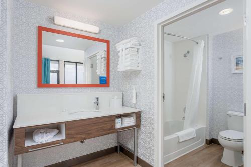 a bathroom with a sink and a toilet and a mirror at Hampton Inn & Suites - Orange Beach in Orange Beach