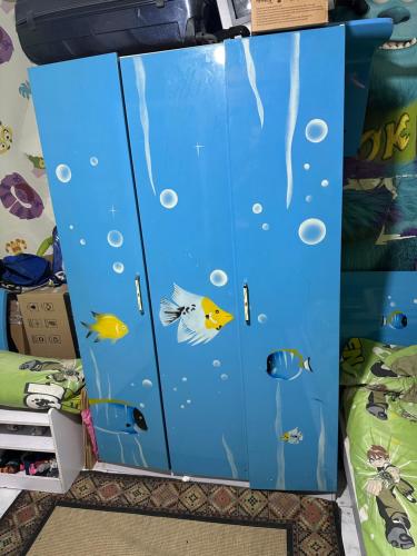 a blue cabinet with fish painted on it at شقه بحديقه رائعه in Cairo