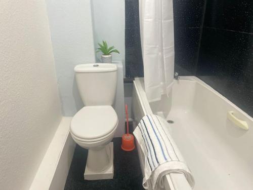 a bathroom with a toilet and a bath tub at One2One - Duplex Relocations in Wakefield