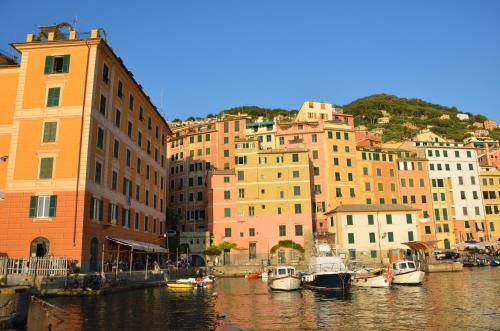 a group of buildings next to a body of water with boats at I Tre Merli Locanda in Camogli