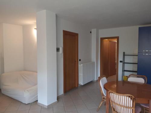 a room with a bed and a table and chairs at Stephanie Residence - in the heart of Alps above Varenna, Lake Como in Esino Lario