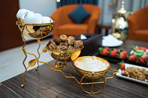 a table with two bowls of food and a plate of food at Jiwar Almasi Hotel in Jeddah