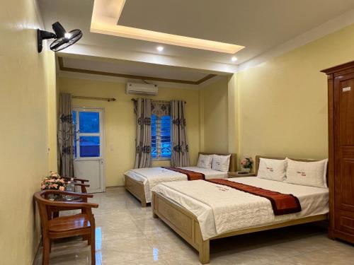 a bedroom with two beds and a ceiling fan at Thien Son Guesthouse in Ha Giang