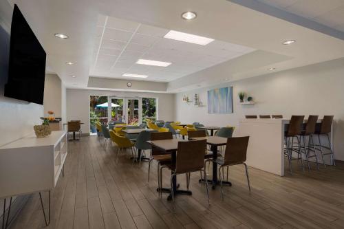 a dining room with tables and chairs in a restaurant at MainStay Suites Wilmington - University Area in Wilmington