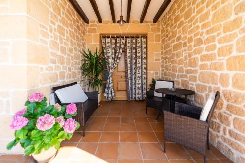 a patio with chairs and a table and flowers at Casa Rural Alvaro in Albares