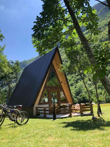 a small cabin with a bike parked in front of it at Family S house - Komarnica in Šavnik