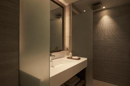 a bathroom with a sink and a mirror at Mare Ayia Napa in Ayia Napa