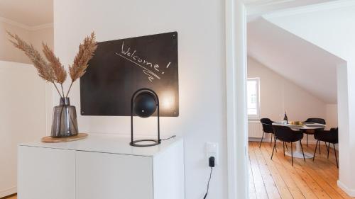a living room with a blackboard on a wall at Stilvoll Wohnen in der kaiserlichen Post in Westerstede