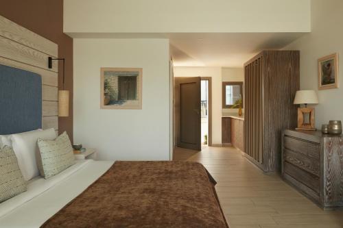 a bedroom with a large bed and a bathroom at Mare Ayia Napa in Ayia Napa