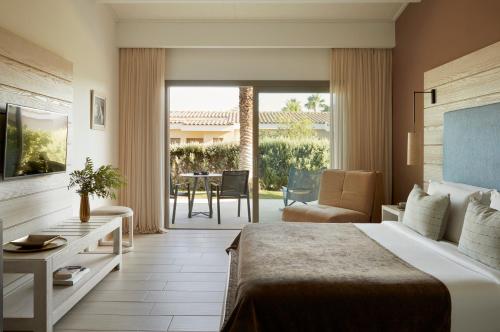 a hotel room with a bed and a table and chairs at Mare Ayia Napa in Ayia Napa