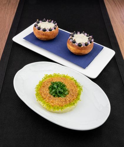 two white plates with donuts on top of a table at Arche Hotel Wrocław Airport in Wrocław