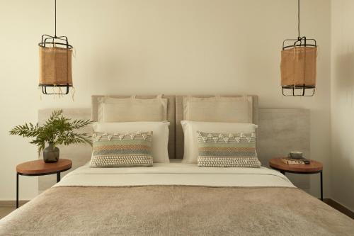 a bedroom with a large bed with pillows on it at Mare Ayia Napa in Ayia Napa