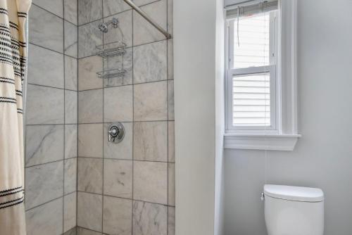 a bathroom with a shower with a toilet and a window at East Cambridge 3br w wd nr cafes bars BOS-910 in Cambridge