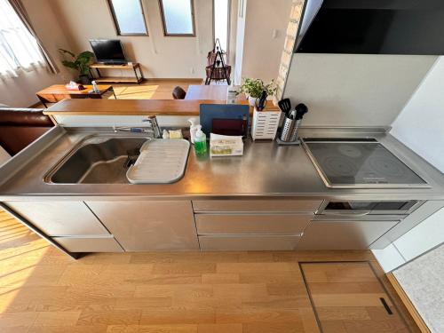a stainless steel kitchen counter with a sink at TENT OKAYAMA - 3 bedrooms, 10 min walk from Okayama Station in Hokancho
