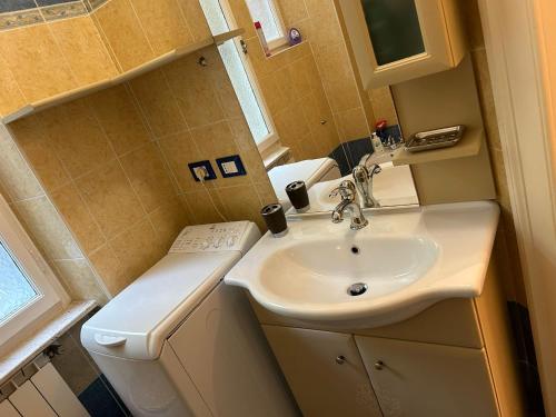 a small bathroom with a sink and a toilet at Casa Xenia in Trieste