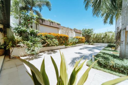 a courtyard of a building with plants and trees at Sugarland Hotel in Bacolod