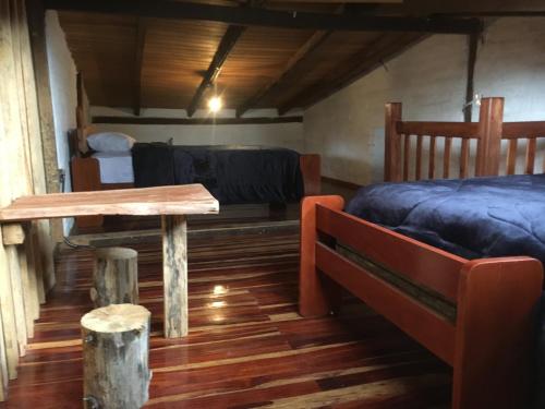 Una habitación con una cama y una mesa en una habitación en CASA DE CAMPO en Riobamba