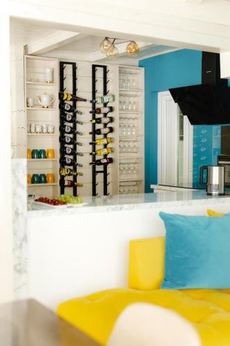 a kitchen with a shelf with wine bottles at Вілла у горах in Krasnik