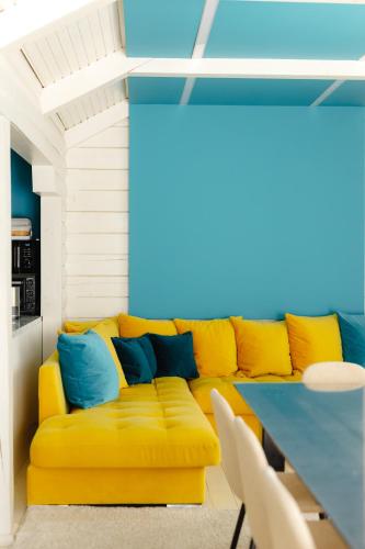 a yellow couch in a room with a table at Вілла у горах in Krasnik