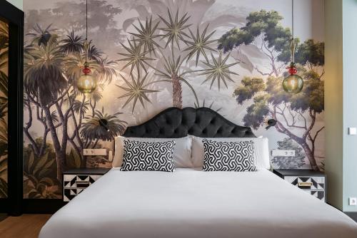 a bedroom with a large bed and a wall with plants at BILBAO DREAMS Luxury in Bilbao