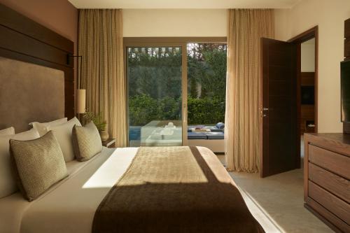 a bedroom with a large bed and a large window at Mare Ayia Napa in Ayia Napa