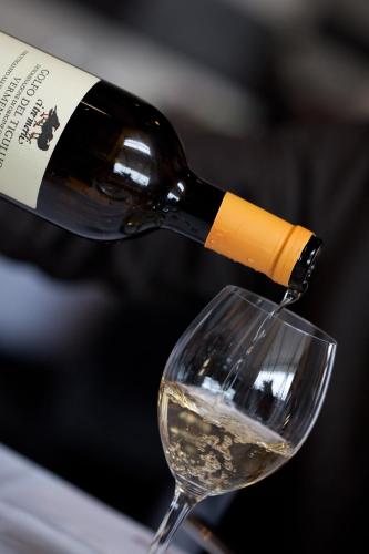 a bottle of wine being poured into a glass at I Tre Merli Locanda in Camogli