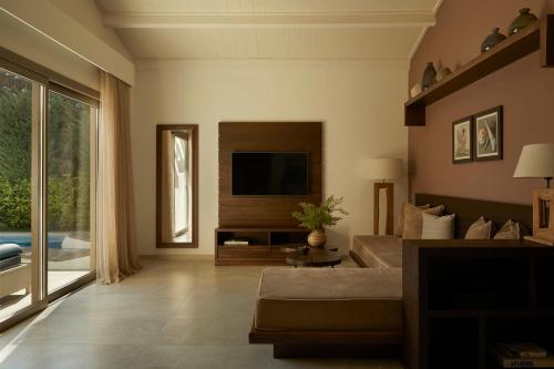 a living room with a television and a couch at Mare Ayia Napa in Ayia Napa