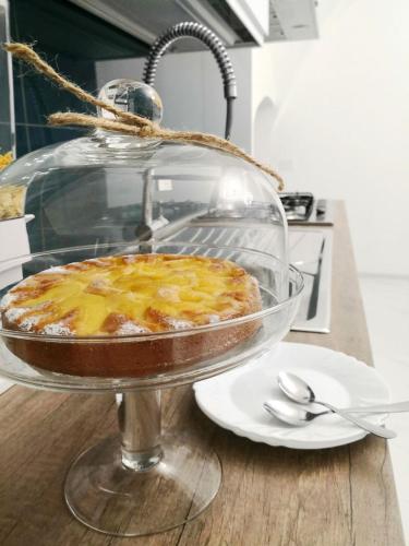 a pie in a glass dish on a table at LianHome b&b "Volte" in Lucera