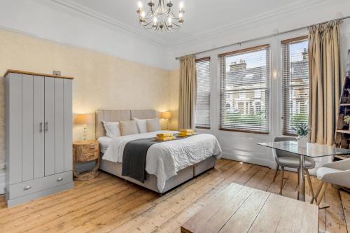 a bedroom with a bed and a table and a chair at Brooklyn Villa in Norwich