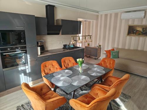 a living room with a dining room table and chairs at Várda-Lak in Kisvárda