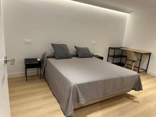 a bedroom with a bed with two pillows on it at Loft Atocha 43 in Madrid