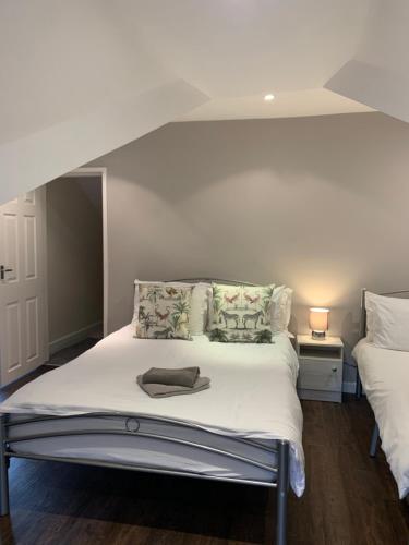 a bedroom with a bed with white sheets and pillows at Pasture Place in Goole