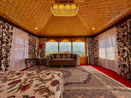 a living room with a couch and a chandelier at New Jacquline Heritage Houseboats in Srinagar
