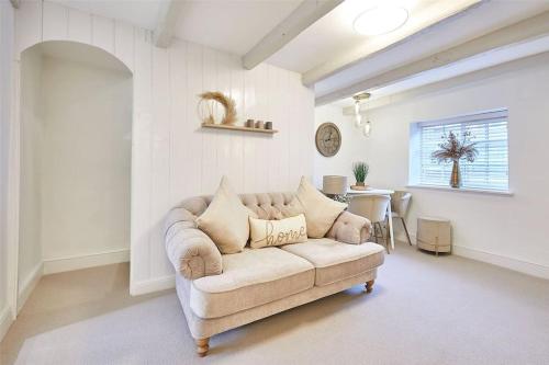 a living room with a couch and a table at Bridge Cottage in Yarm in Yarm