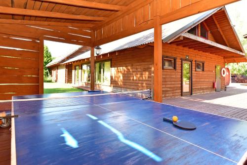 a ping pong table in front of a building at Aerodream Trakai in Antakalnis