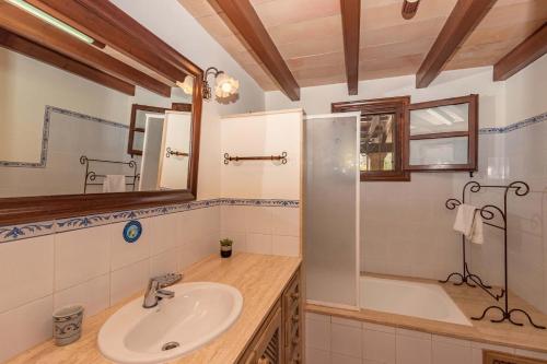 a bathroom with a sink and a tub at Villa Camp del Bosch by Sealand Villas in El Port