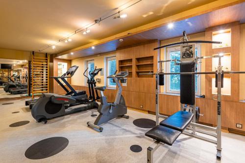 a gym with treadmills and ellipticals in a room at Castrum Hotel Székesfehérvár in Székesfehérvár