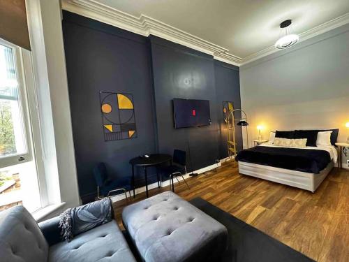 Stylish studio for 3 near Regent’s Park n3 في لندن: غرفة معيشة مع سرير وأريكة