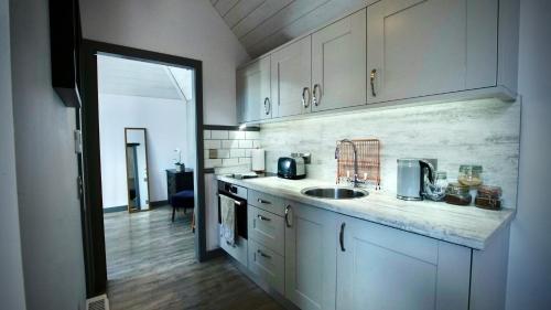 a kitchen with a sink and a counter top at The Lodges @ Barra Castle in Inverurie
