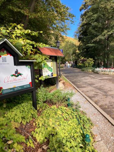 a sign in a park next to a street at Castrum Visum Wernigerode in Wernigerode
