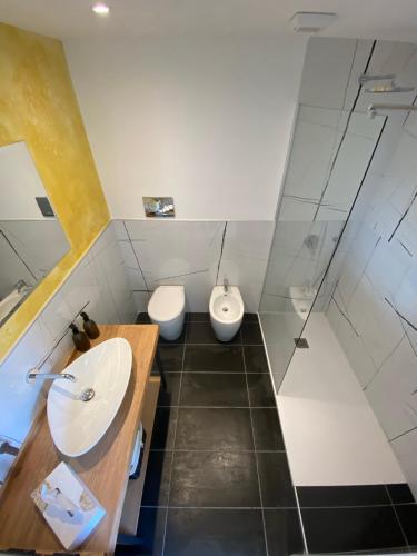 a bathroom with a sink and a toilet at Hotel San Teodoro in San Teodoro