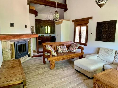 a living room with a couch and a fireplace at Cortijo la Noria II in Puebla de Don Fadrique